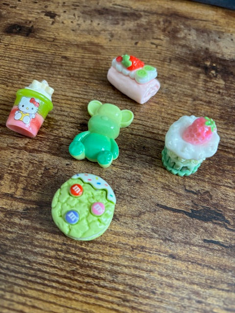 Colorful miniature food-shaped objects on a wooden surface