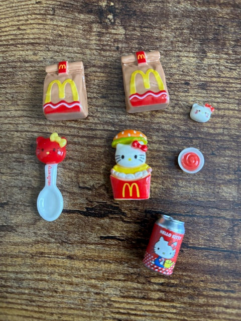 Set of small decorative items resembling McDonald's products on a wooden surface