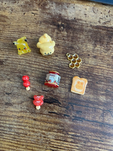 Set of miniature food figurines on a wooden surface