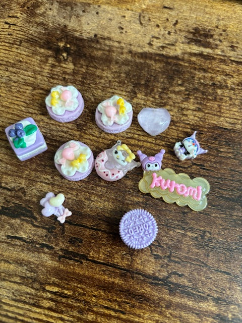 Small purple decorative items on a wooden surface