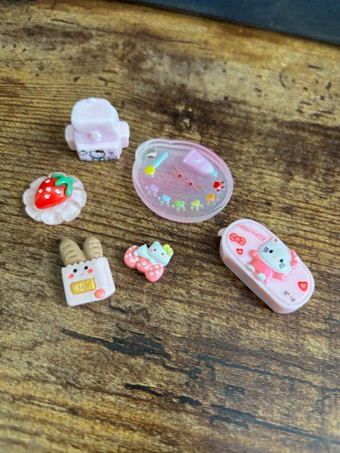 Small decorative items - Backpack, pallet, pencil pouch, bread, and bow on a wooden surface