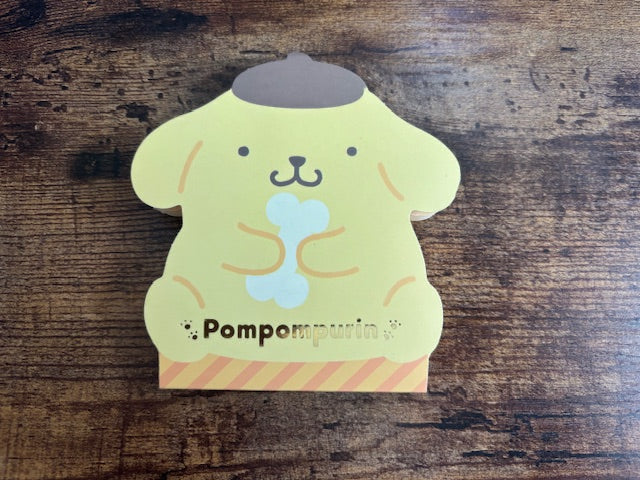 Pom pom purin character notepad on a wooden surface