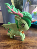 Green nature dragon figure on a wooden surface