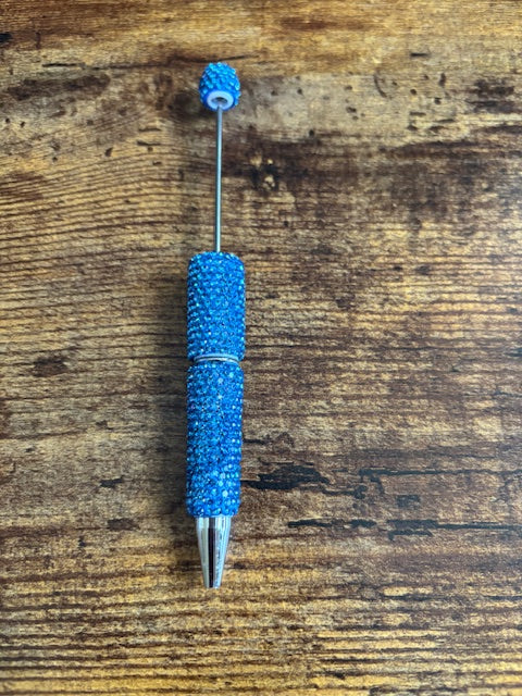 Blue textured pen on a wooden surface